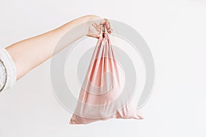 Ban single use plastic. Woman holding in hand groceries in reusable eco bag. Zero Waste shopping concept. Choose eco friendly