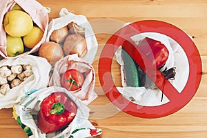 Ban single use plastic. Zero Waste shopping concept. Fresh groceries in reusable eco bags and vegetables in plastic polyethylene
