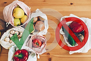 Ban single use plastic. Zero Waste shopping concept. Fresh groceries in reusable eco bags and vegetables in plastic polyethylene