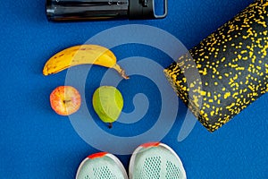 banana, apple, pear and exercise equipment placed on the mat. Replenishment of energy during training or workout