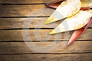 Banana blossom slice on wooden background.Raw food or background food.