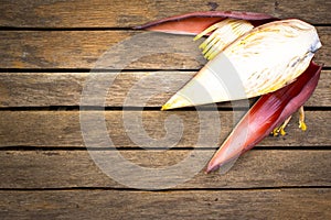 Banana blossom on wooden background.Raw food
