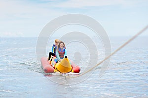 Banana boat ride. Kids on the beach