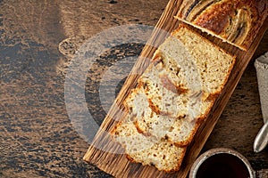 Banana bread. Cake with banana, traditional american cuisine. Slices of loaf. Dark background