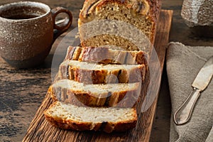 Banana bread. Cake with banana, traditional american cuisine. Slices of loaf. Dark background