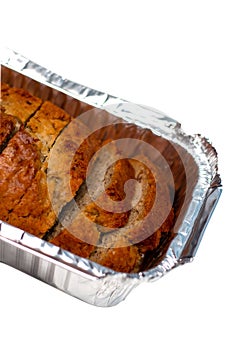 Banana bread loaf cut in pieces isolated on white background