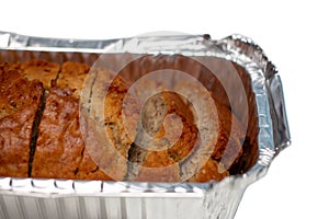 Banana bread loaf cut in pieces isolated on white background