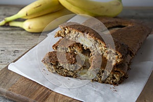 Banana bread with oat flour. Top view of homemade banana bread on wooden background. Ideas and recipes for healthy diet breakfast