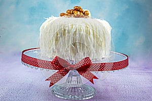 Banana cake sacakli yas pasta with white chocolate. on pink wooden background. pastry shop concept