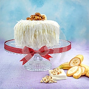 Banana cake sacakli yas pasta with white chocolate. on pink wooden background. pastry shop concept