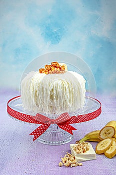 Banana cake sacakli yas pasta with white chocolate. on pink wooden background. pastry shop concept