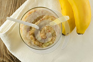 Banana and celery smoothie with berries on wooden table top view