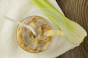 Banana and celery smoothie with berries on wooden table top view