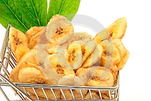 Banana chips with green leaves in metal trolley