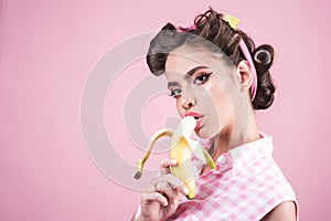 Banana dieting. pin up woman with trendy makeup. pinup girl with fashion hair. retro woman eating banana. pretty girl in