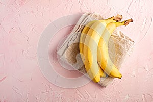 Banana fruits with tablecloth on pink textured background