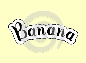 Banana. Handwritten calligraphic text with white and black stroke on yellow background. Name of fruit.