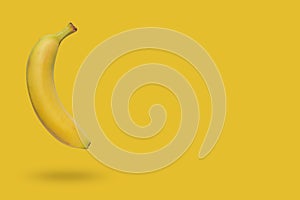 Banana isolated on yellow background with a shadow