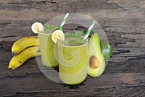 Banana Juice and avocado smoothies and green juice drink healthy, delicious taste in a glass for weight loss on wooden background