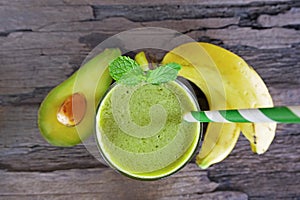 Banana Juice and avocado smoothies and green juice drink healthy, delicious taste in a glass for weight loss on wooden background.