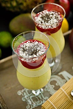 Banana and mango smoothie dessert in wine glasses