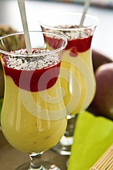 Banana and mango smoothie dessert in wine glasses