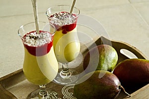 Banana and mango smoothie dessert in wine glasses