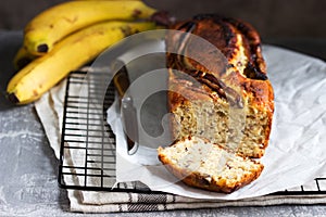 Banana muffin with candied ginger and raisins and bananas on a gray background