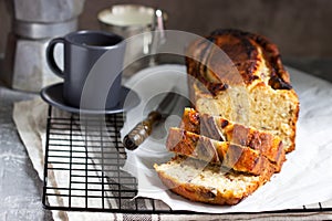 Banana muffin with candied ginger and raisins and drinks on a gray background