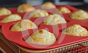Banana nut muffins in a red baking pan