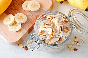 Banana nut overnight oats in glass canning jar, downward view photo