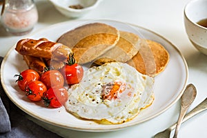 Banana Oat Pancakes with Fried egg,Sausages and Cherry Tomatoes