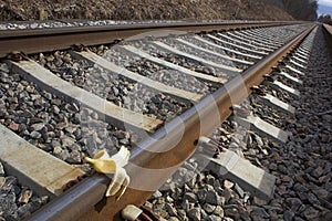 Banana peel on railway. Train Sabotage humoristic conceptual image