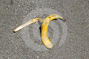 Banana peel was left on the asphalt. The danger may slip. If anyone walks on it