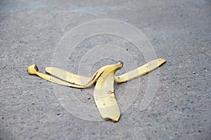Banana peel was left on the concrete floor. The danger may slip.
