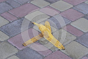 Banana peel was left on the pavement. The danger may slip. If anyone walks on it. Be careful of slippery. Closeup, outdoors