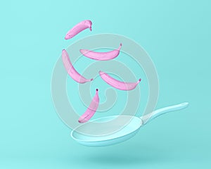 Banana pink floating with pan on pastel blue background. minimal  concept fruits and food