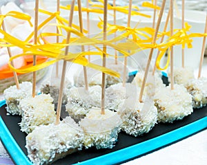 Banana pops with chocolate, nuts, coconut powder