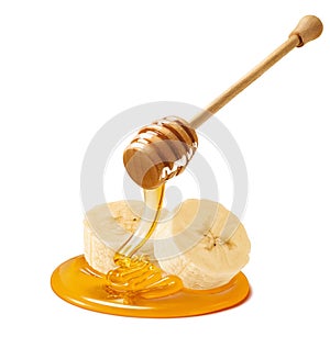 Banana slices and honey dipper isolated on white background