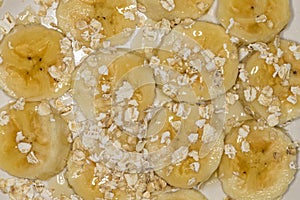 Banana slices with oats and honey close up