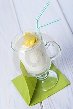 Banana smoothie decorated with a lemon zest photo