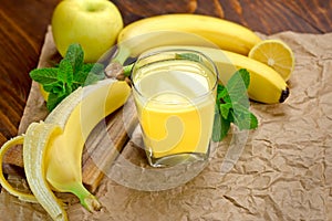 Banana smoothie (juice) and banana on table - healthy drink (healthy beverage)