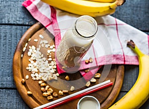 Banana smoothie with oat flakes and milk in the bottle