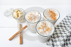 Banana smothie or milkshake with cinnamon on white  background
