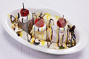 Banana split dessert with chocolate, vanilla and strawberry ice cream