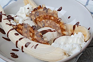 banana split with ice cream, chocolate, waffles