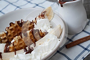 Banana split with ice cream, chocolate, waffles