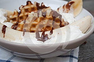 Banana split with ice cream, chocolate, waffles