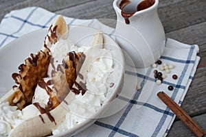 Banana split with ice cream, chocolate, waffles