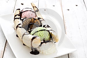 Banana split ice cream dessert with chocolate syrup